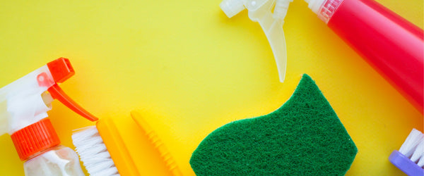 Sponge, brush, and spray bottles to clean a mattress