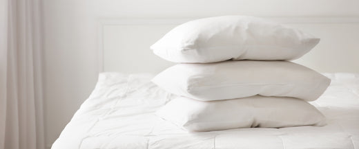 Three pillows stacked on bed