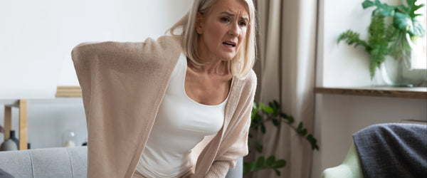 Woman holding back due to back pain