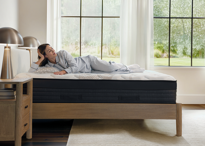 Woman lying on Nolah Evolution mattress with premium pressure relief.